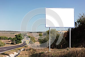 Empty billboard for advertising poster near asphalting road. Background of blue sky and beautiful nature.
