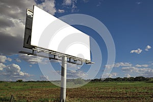 Empty billboard in front of beautiful cloudy sky in a rural location