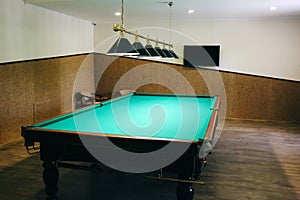 Empty billiard table with lamps above it. Sports and indoor games free time concept