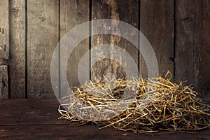 empty bird nest made of dry straw on wooden background