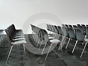 Empty black chairs rows in conference room