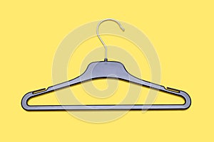 Empty black hanger isolated on a yellow background close up
