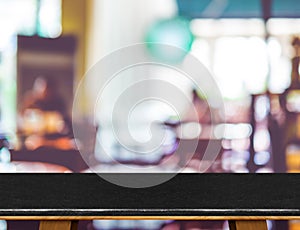 Empty black marble table and blurred cafe bokeh light background