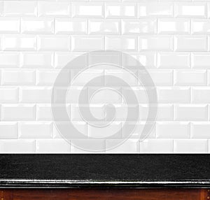 Empty black marble table and ceramic tile brick wall in background. product display template.