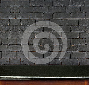 Empty black marble table and white black brick wall in background. product display template.