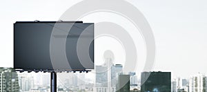 Empty black mock up banner in dull city sky. Commercial concept.