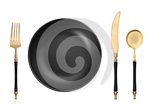 Empty black plate with golden fork, knife and spoon on white background, top view