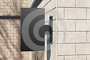 Empty black rectangular mock up stopper on beige outdoor tile wall background with shadows.