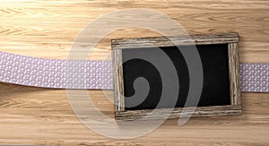 Empty blackboard on rustic wooden background with loop tape 3d Rendering