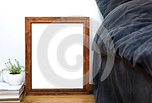 Empty blank vintage wooden frame on a floor, home bedroom interi