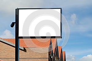 Empty blank white mockup template of a signpost with a brick building in the background.