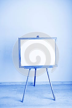 Empty blank whiteboard in the room made of Classic Blue 2020 color. Color of year 2020 blurred sparkling backdrop for holidays and