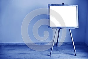 Empty blank whiteboard in the room made of Classic Blue 2020 color. Color of year 2020 blurred sparkling backdrop for holidays and