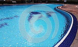 Empty Blue Mosaic swimming pool with sparkling ripples