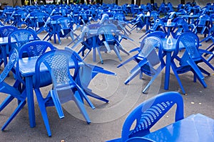 empty blue plastic chairs and tables outside, preparing for the holiday, no people