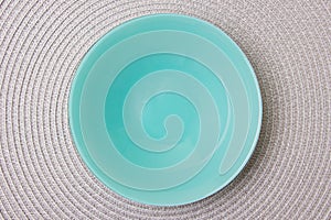 Empty blue plate on gray spiral tissue background