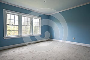 Empty blue room with large white window