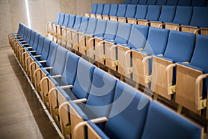 Empty blue seats in a conference room