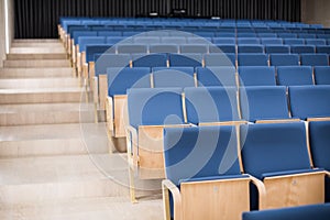 Empty blue seats in a conference room