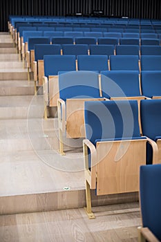 Empty blue seats in a conference room