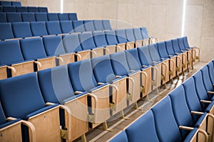 Empty blue seats in a conference room