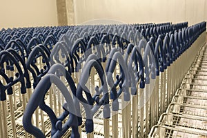 Empty blue shopping cart at supermarket entrance, trolleys car supermarket