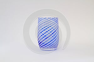 Empty blue waterglass on white background.