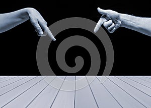 Empty blue wooden table with man and woman hands pointing on it on black background. Ready for product display montage