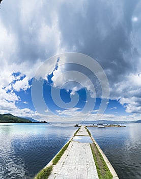 Empty boat port on calm water surface lake in Ohrid