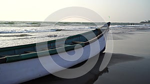 Empty boat on sandy beach in bright day. Large old white boat on sandy seaside ready to sail in bright day on beach