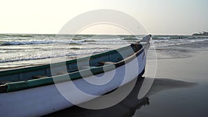 Empty boat on sandy beach in bright day. Large old white boat on sandy seaside ready to sail in bright day on beach