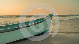 Empty boat on sandy beach in bright day. Large old white boat on sandy seaside ready to sail in bright day on beach