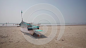 Empty boat on sandy beach in bright day. Large old white boat on sandy seaside ready to sail in bright day on beach