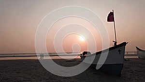 Empty boat on sandy beach in bright day. Large old white boat on sandy seaside ready to sail in bright day on beach