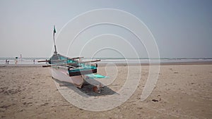 Empty boat on sandy beach in bright day. Large old white boat on sandy seaside ready to sail in bright day on beach