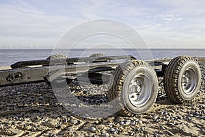 Empty boat trailer on the beach