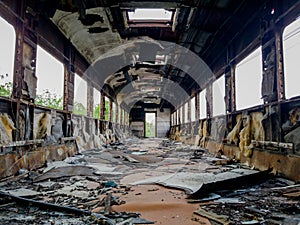 Empty bogey of the retired train with rusty debris and garbage inside