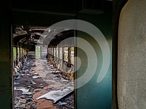 Empty bogey of the retired train with rusty debris and garbage inside