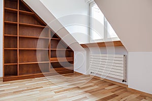 Empty bookshelf in the attic