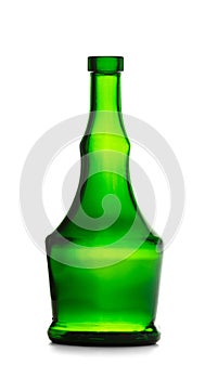 An empty bottle of an unusual shape made of dark green glass for cognac, whiskey on a white background