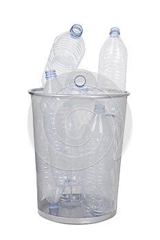 Empty bottles in garbage bin over white background