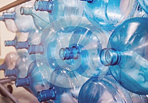Empty bottles are stacked in a row. Cleaning of plastics in the production of pure water