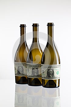 Empty bottles of wine from the label of dollar bill