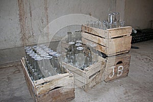 Empty bottles in wooden boxes photo
