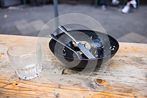 Almost empty bowl and empty water glass left by a customer after eating in the eatery