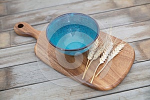 An empty bowl and a few ears of wheat