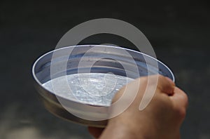 Empty bowl in hand as concept of global famine and hunger crisis