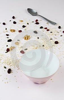 Empty bowl with healthy cereal spilled on the table
