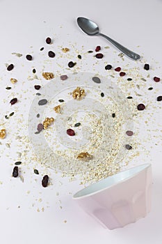 Empty bowl with healthy cereal spilled on the table