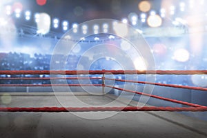 Empty boxing ring with red ropes for match